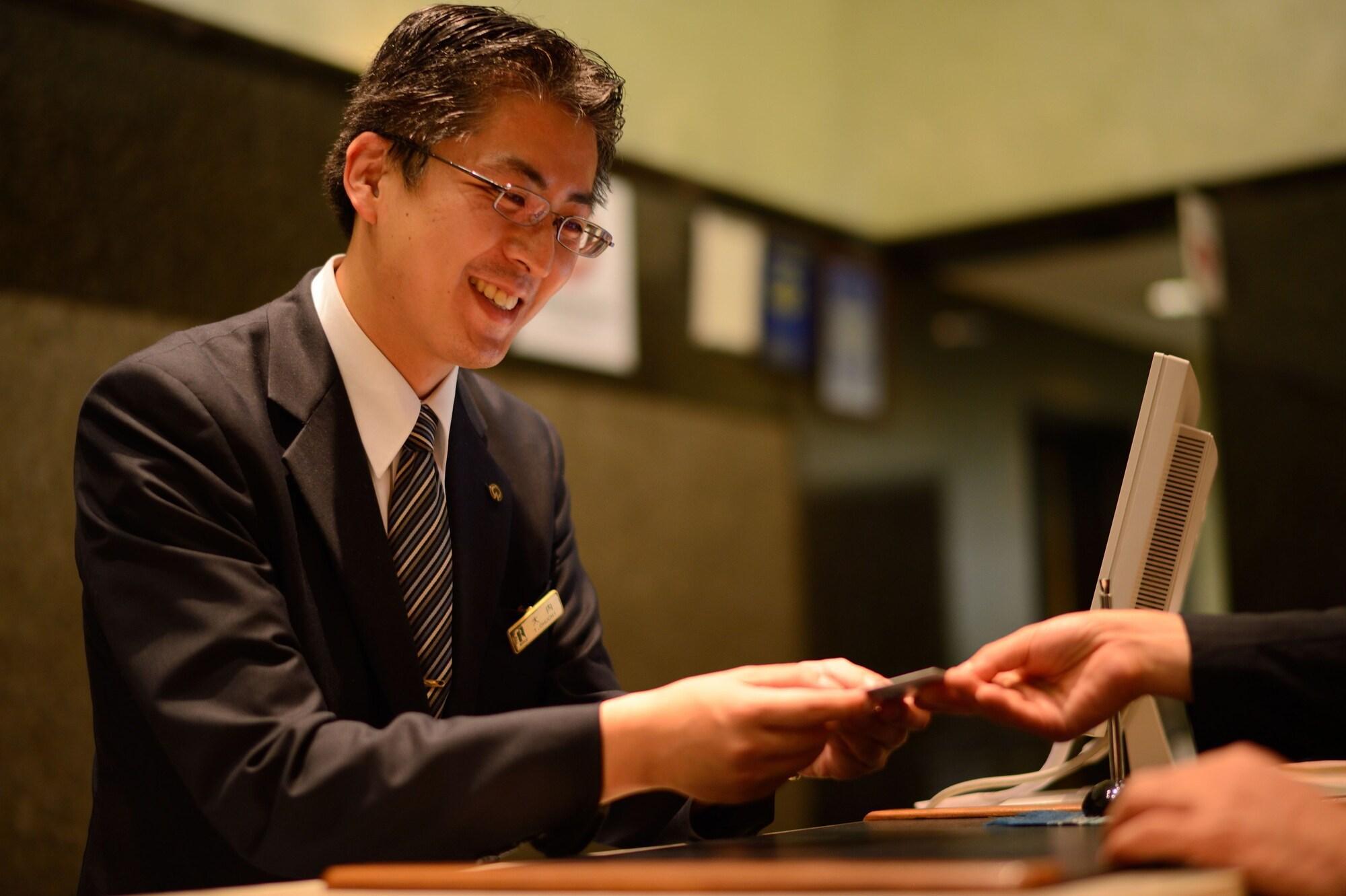 Royton Sapporo Hotel Экстерьер фото A hotel clerk at the front desk